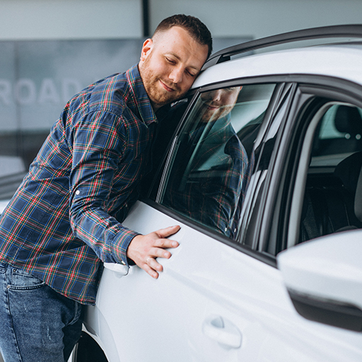 Man hugging his car